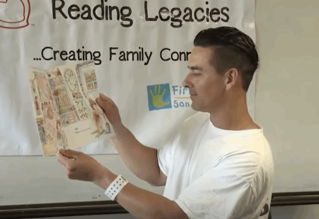 Incarnated Dad reading book for his child while volunteer records